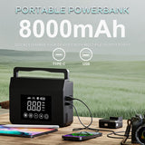 Le booster utilisé en power bank sur une table de camping — sorties USB-C et USB-A